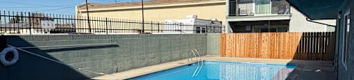 A small pool with a black fence around it.