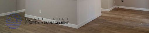 A room with a counter and a logo for Beach Front Property Management.
