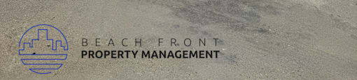 A white building with a sign that says Beach Front Property Management.