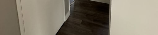 a small hallway with a door to a bedroom and a closet