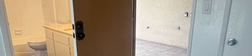 A room with a wooden floor and a door with the number 16 on it.