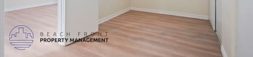 A room with a door and a window, managed by Beach Front Property Management.