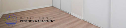 A room with a window and a logo for Beach Front Property Management.