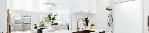 A modern kitchen with a large island and stainless steel appliances.