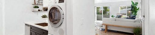 A laundry room with a washer and dryer stacked on top of each other.