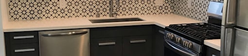 a kitchen with black appliances and white cabinets