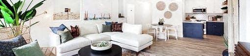 A living room with a white sofa and a coffee table.