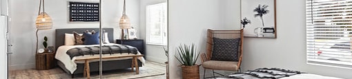 A bedroom with a bed, chair, and a mirror.