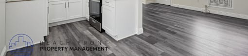 a kitchen with white cabinets and a stove and a microwave