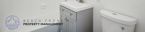 a white bathroom with a sink and toilet and a mirror