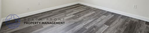 a bedroom with wood flooring and a ceiling fan