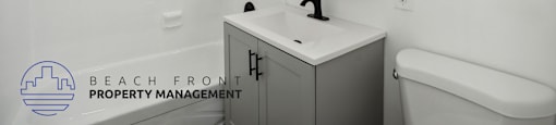 a white bathroom with a sink and a mirror and a toilet
