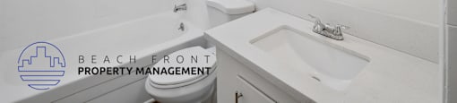 A white bathroom with a sink, toilet, and bathtub.