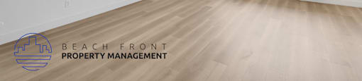 A room with a window and a logo for Beach Front Property Management.