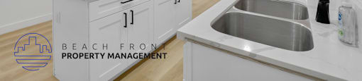 A modern kitchen with a sink and a logo for Beach Front Property Management.