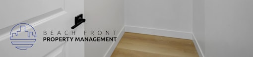 A white room with a logo for Beach Front Property Management.