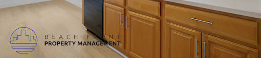 A kitchen with wooden cabinets and a white countertop.