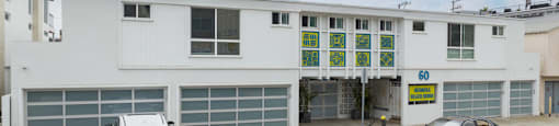 A white building with a sign that says "60" on it.