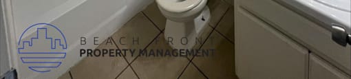 a bathroom with a toilet and a sink and a bath tub