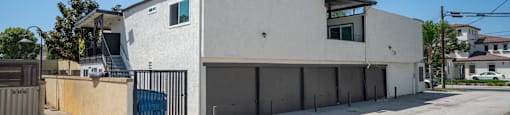 A modern building with a flat roof and a garage door.