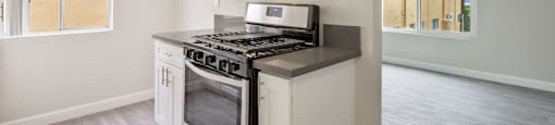 A kitchen with a stove, microwave, and oven.