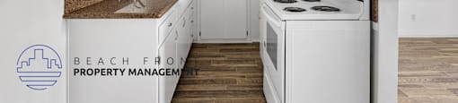 A kitchen with white cabinets and a white stove top oven.