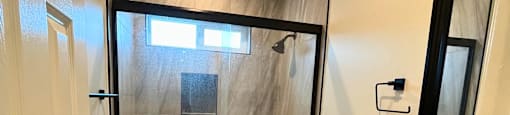 a small bathroom with a shower toilet and sink
