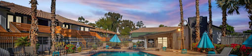 a swimming pool with palm trees in the background