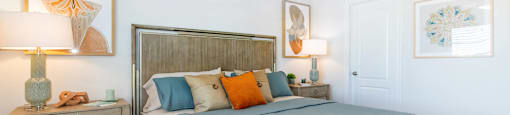 A bedroom with a bed, nightstand, and a ceiling fan.