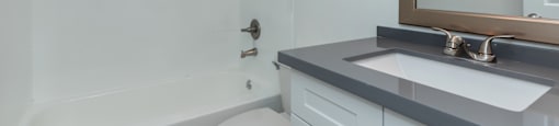 an empty bathroom with a sink toilet and shower