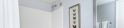 A white toilet sits next to a white bathtub in a bathroom.