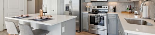 A modern kitchen with a dining table and bar stools.