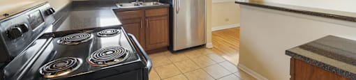 Spacious kitchen with stainless steel appliances and wood cabinets