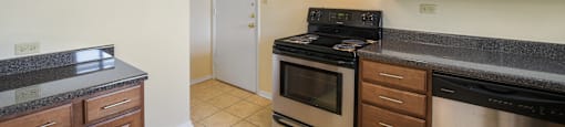 Spacious kitchen with stainless steel appliances and wood cabinets