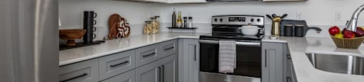 A kitchen with a stove top oven and a microwave above it.