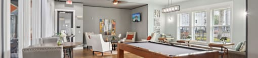 A room with a pool table and a television.