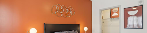 A bedroom with a bed, nightstand, and a ceiling fan.
