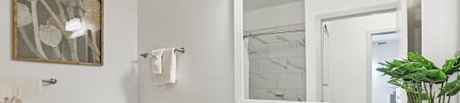 A bathroom with a toilet, sink, and mirror.