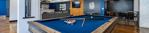 a billiards table in a room with a blue pool table