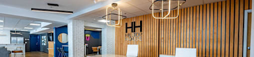 a conference room with a blue counter and yellow chairs