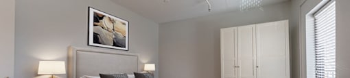 a bedroom with a large bed and a white couch