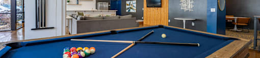 a pool table in a room with a tv