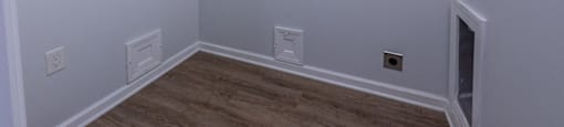 a large white room with a wood floor and white walls