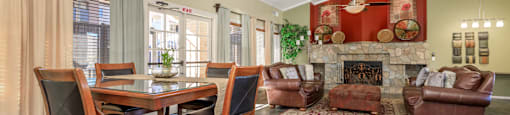 A dining room with a table set for four.