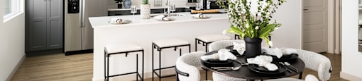 A modern kitchen with a dining table set for four.