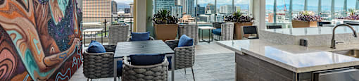 A modern kitchen and dining area with a view of the city.