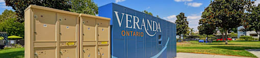 A large sign that says Veranda Ontario stands in front of a row of portable toilets.