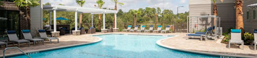 pool view with view of palm trees and clouds