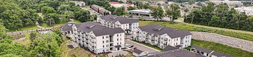 A large white building with a parking lot in front of it.