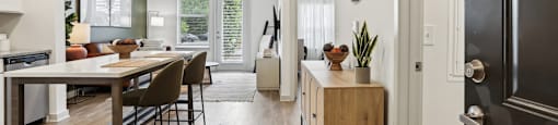 A modern kitchen with a wooden table and chairs.